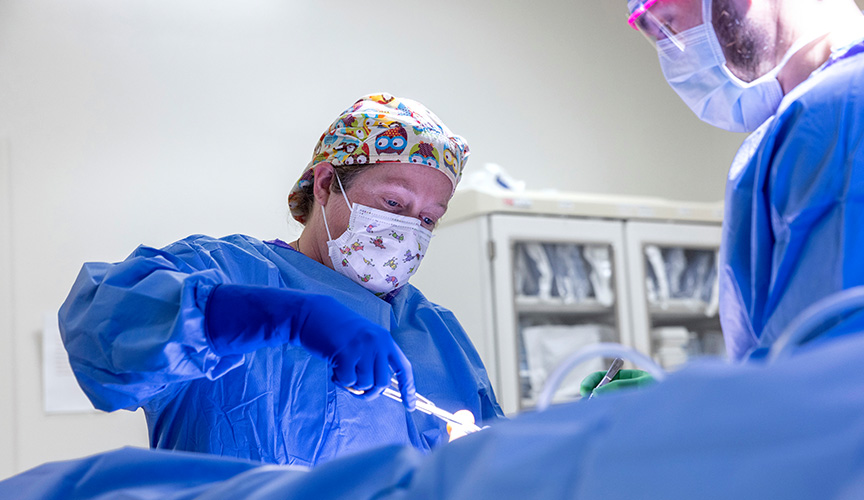 Surgeon in the operating room conducting surgery.